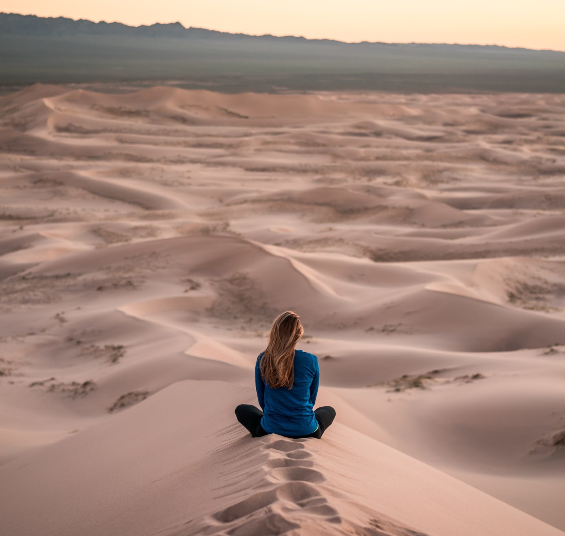 Person meditating in the desert